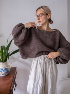 "Stylish chunky crop sweater with long balloon sleeves and boat neckline. Can be made to order in any color from the color card. Materials: wool blend (wool/acrylic) Color of the modeled sweater: brown melange - made in size S/M (see the measurements) Measurements of size S/M: Length: front 18\" = 46 cm back 20\" = 50 cm Chest: 32\" = 81 cm Measurements of size L/XL Length: front 20\" = 50 cm back 22\" = 55 cm Chest: 34\" = 86 cm Measures of Model in the photo Size: S Chest: 32\" - 82 cm Waist: Knit Chunky Sweater, Oversized Cropped Sweater, Chunky Knit Jumper, Womens Pullover Sweaters, Pullover Outfit, Cropped Pullover, Oversized Pullover, Pullover Sweater Women, Boat Neckline