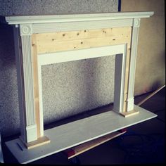 an unfinished fireplace surround being built with plywood