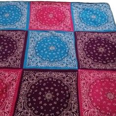 an image of a colorful bandana on a white tablecloth with pink, blue and red squares