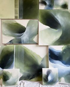 four abstract paintings are displayed on the wall