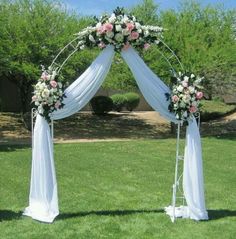 an outdoor wedding setup with white and pink flowers