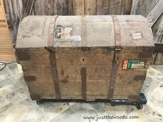 an old wooden trunk sitting on top of a dolly