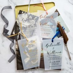 the wedding stationery is laid out on top of a table with ribbon and ribbons