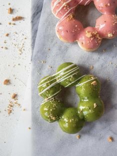 doughnuts with sprinkles and green peppers on a piece of paper