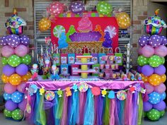 a birthday party with balloons, candy and decorations