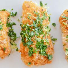 three pieces of food on a plate with parsley sprinkled on top and another piece of bread in the middle