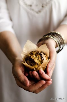 a close up of a person holding food in their hands