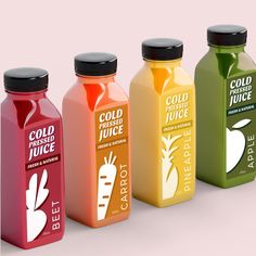 four different colored juices are lined up in a row