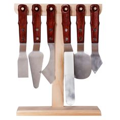 four knives are hanging on a wooden rack