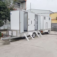 two portable restrooms are parked next to each other