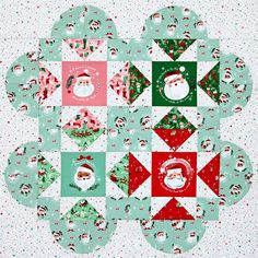 a christmas quilt with santa's faces on it and snowmen in the background