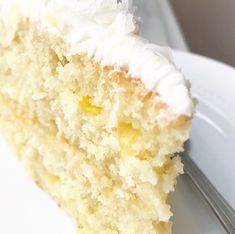 a slice of white cake on a plate with a fork