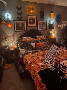 a bedroom decorated for halloween with pumpkins on the bed and decorations hanging from the wall