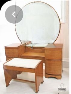 an antique dressing table with mirror and stool