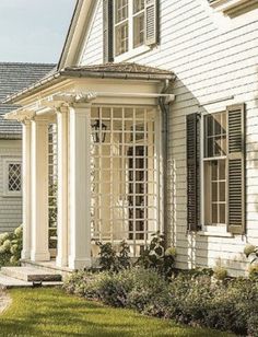 a white house with black shutters and windows