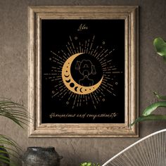 a black and gold framed print with the moon