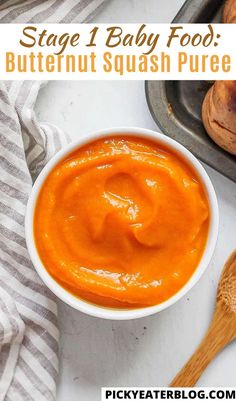 a bowl of butternut squash puree next to some bread