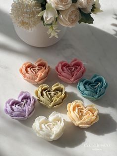 several different colored flowers in a vase on a table