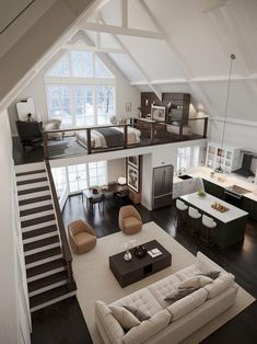 an aerial view of a living room and kitchen area in a loft with high ceilings