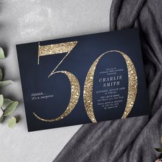 a 50th birthday party card with gold glitter on it and the number fifty written in black