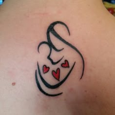 a tattoo on the back of a woman's shoulder that has hearts in it