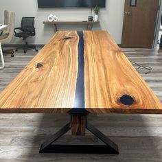 a wooden table sitting in front of a flat screen tv