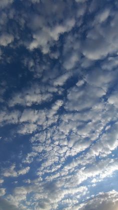 the sky is filled with white clouds and blue skies