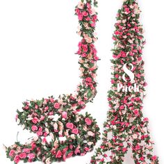 the eiffel tower is covered in pink flowers and greenery, with one leaning on it's side