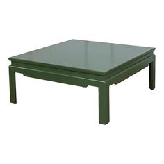 a green coffee table sitting on top of a white floor