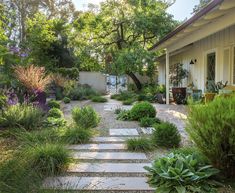 an outdoor garden with steps leading up to the house