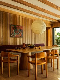 a dining room with wooden walls and chairs