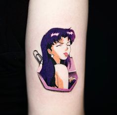 a woman's arm with a cartoon character tattoo on the left side of it