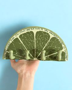 a person holding up a money bill shaped like a fan