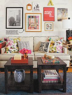 a living room filled with lots of furniture and pictures on the wall above it's coffee table