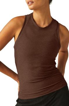 Move from the yoga studio to running errands in ultimate comfort in this superstretchy tank boasting a sporty racerback and subtly ruched seams. 21" length (size Medium) Crewneck Racerback 94% polyester, 6% elastane Machine wash, tumble dry Made in the USA of imported fabric Brown Sleeveless Sports Top, Brown Fitted Sleeveless Activewear, Stretch Brown Sports Tops, Brown Stretch Sports Tops, Sporty Brown Stretch Top, Sporty Stretch Brown Tops, Fitted Brown Top For Yoga, Brown Sleeveless Activewear For Sports, Fitted Brown Workout Tops