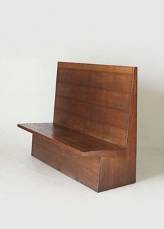 a wooden bench sitting on top of a white floor