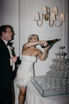 a woman in a white dress holding a champagne bottle