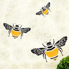 three bees are flying in the air with their wings spread out and one is yellow