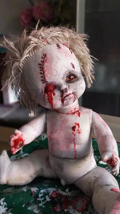 a creepy doll with blood all over it's body