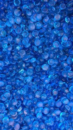 many blue bubbles are floating in the water