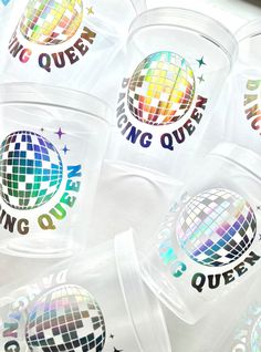 plastic cups with disco balls on them and the words dancing queen written in large letters