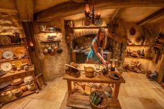 a woman standing in front of a table filled with dishes