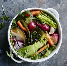 a bowl filled with vegetables sitting on top of a table