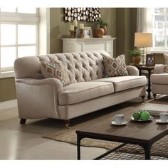 a living room with two couches and a coffee table in front of a window