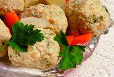 meatballs and vegetables in a glass bowl on a lace tablecloth covered table cloth