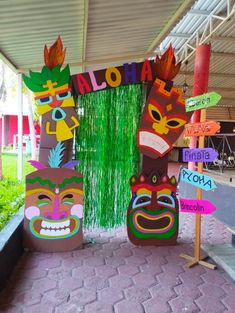 an outdoor area decorated with paper mache masks