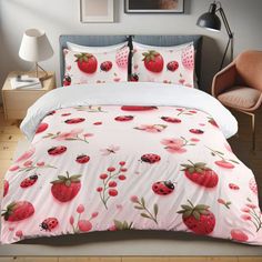 the bed is covered with pink strawberrys and ladybugs