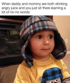 a toddler wearing a plaid hat and looking at the camera