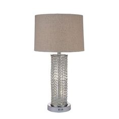 a table lamp with a beige shade on it