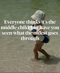 a little boy walking in the water with a hat on his head and an inscription that reads, everyone thinks it's the middle child but have you seen what the oldest goes through